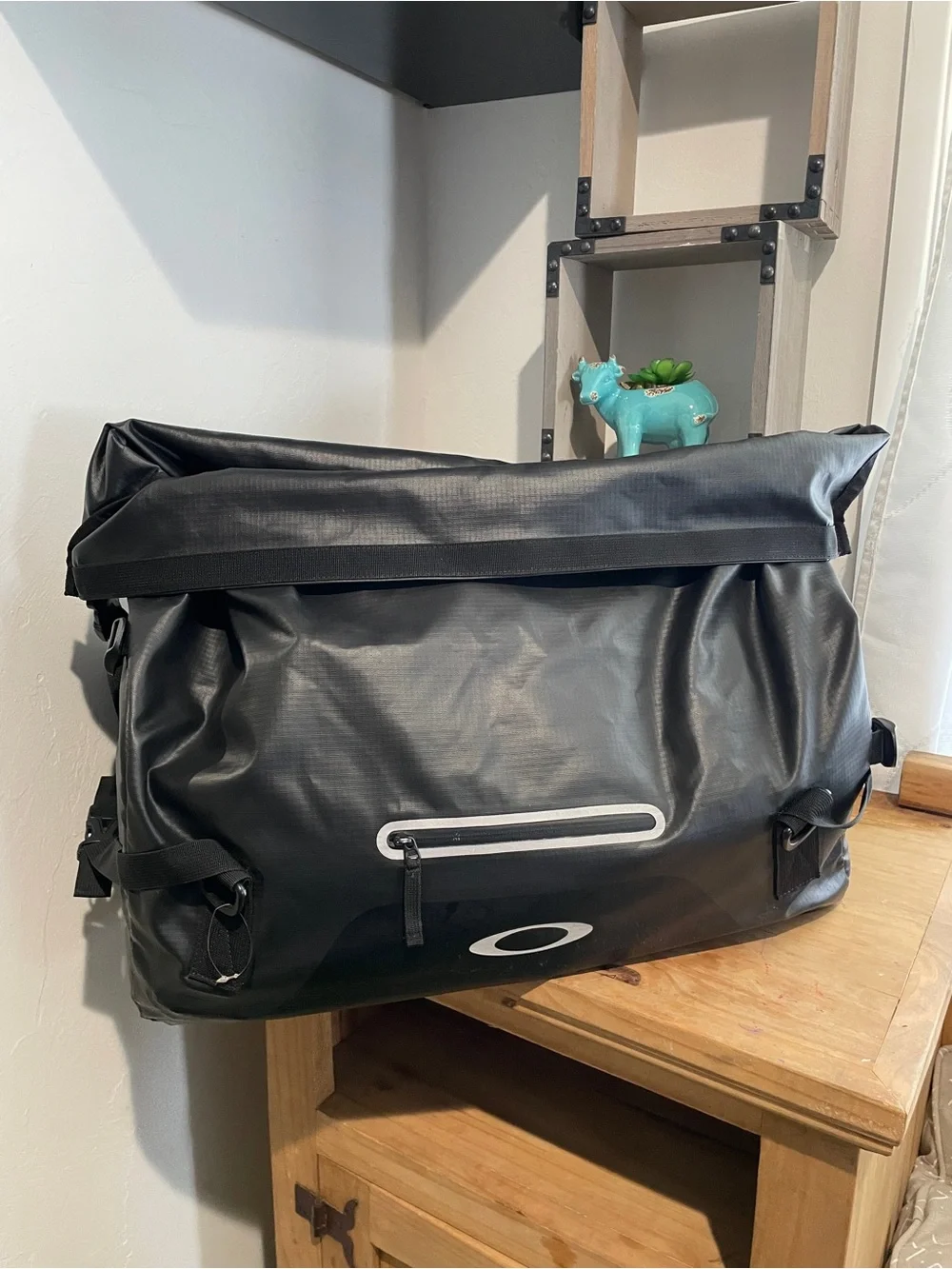 Oakley Motion 42 canvas bag in black features a waterproof roll-top design.